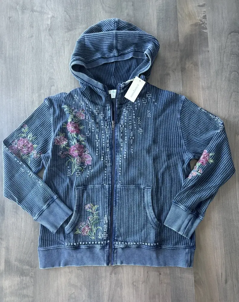 The Jolene Floral Hoodie in indigo blue with the same floral vine embroidery