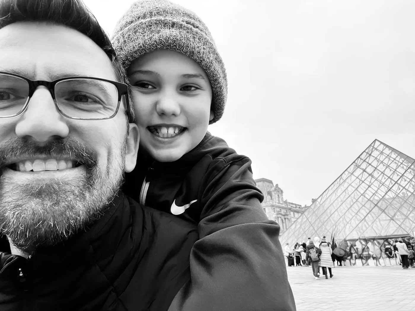 Michael and his son in front of the Louvre pyramid in Paris