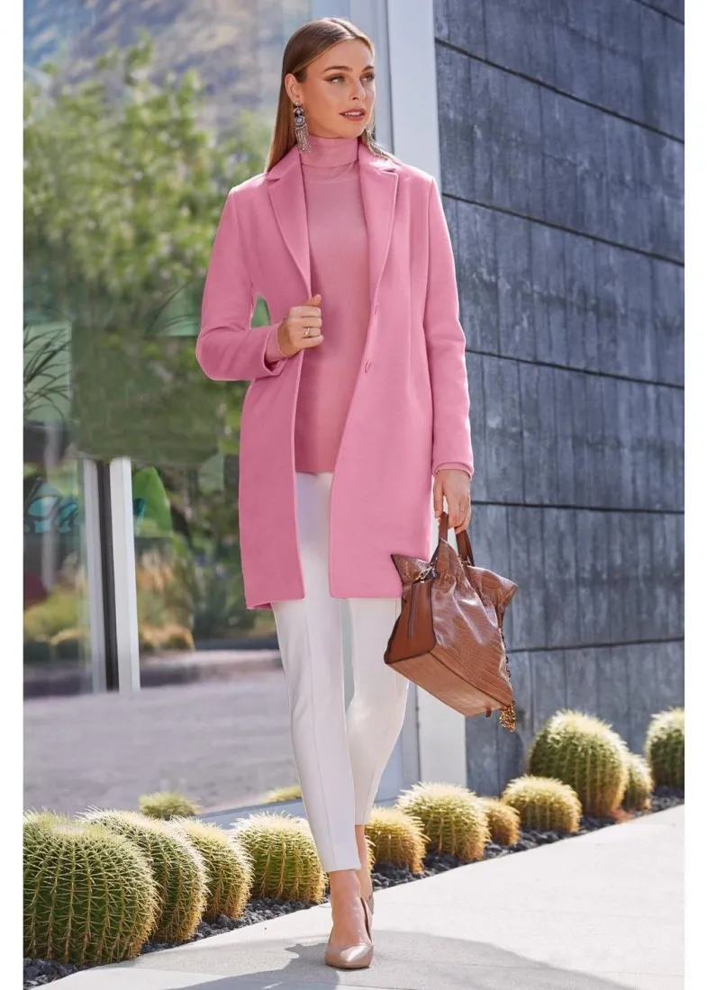 The wool topper worn in pink with white pants and a tan handbag